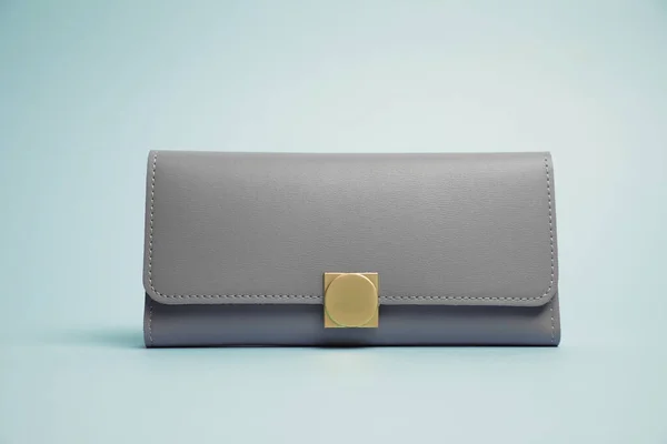 Stylish leather purse on light blue background