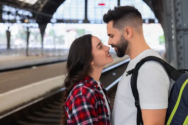Long-distance relationship. Beautiful couple on platform of railway station
