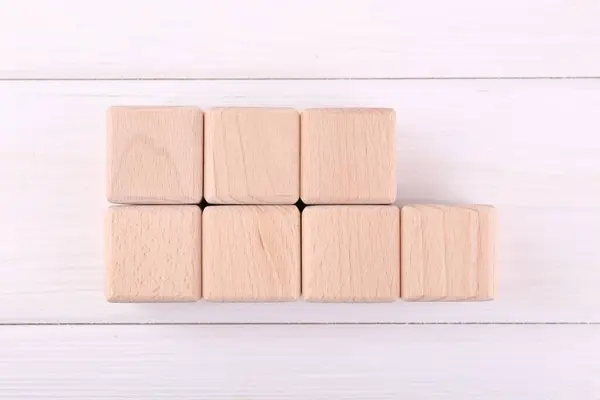 International Organization for Standardization. Cubes with abbreviation ISO and number 9001 on white wooden table, flat lay