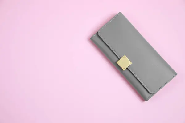 Stylish grey leather purse on pink background, top view. Space for text