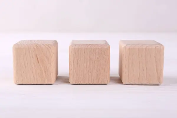 International Organization for Standardization. Wooden cubes with abbreviation ISO on white table, closeup