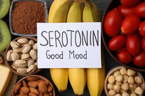 Many different products and card with phrase Serotonin Good Mood on table, flat lay. Natural antidepressants
