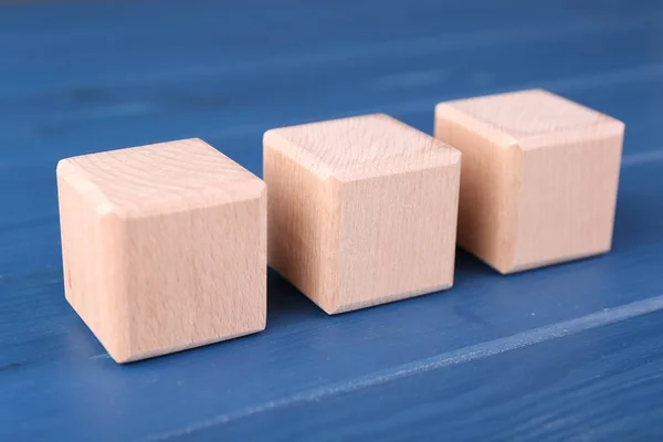 International Organization for Standardization. Cubes with abbreviation ISO on blue wooden table, closeup