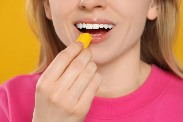 Woman Putting Bubble Gum Mouth Yellow Background Closeup — Stock Photo, Image