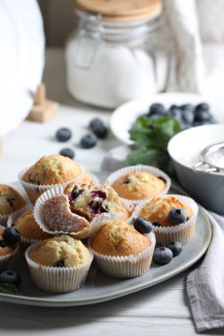 Beyaz ahşap masada yaban mersinli lezzetli çörekler.