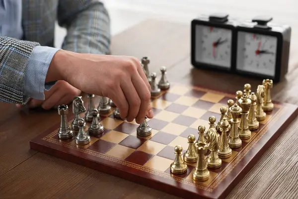 Man playing chess during tournament at table, closeup