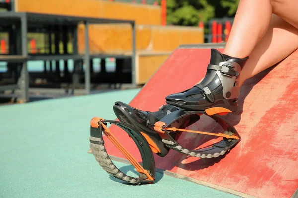 stock image Woman with kangoo jumping boots in workout park, closeup