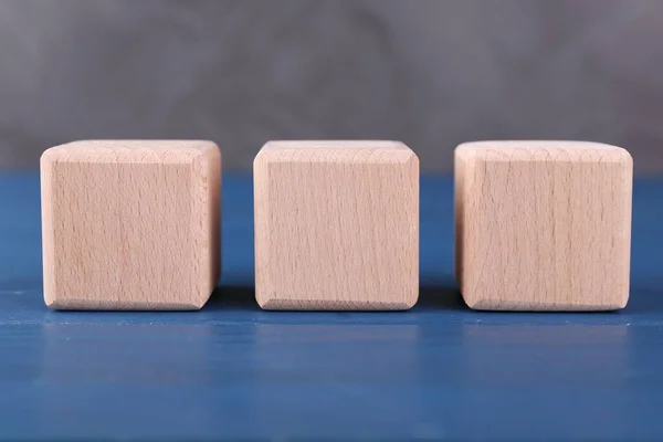 International Organization for Standardization. Cubes with abbreviation ISO on blue wooden table, closeup