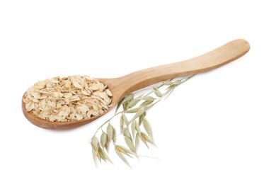 Tahta kaşık yulaf ezmesi ve beyaz çiçekli dal.