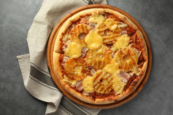 Delicious pineapple pizza on gray table, top view