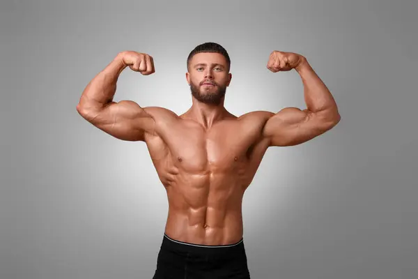 stock image Young bodybuilder with muscular body on light grey background