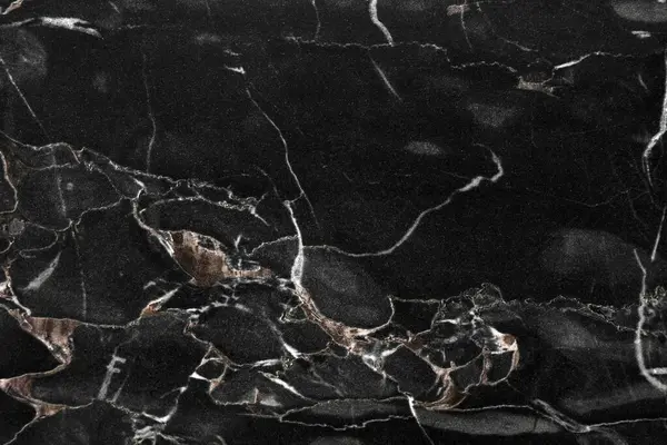 Arkaplan olarak siyah mermer taş yüzeyinin dokusu, yakın plan
