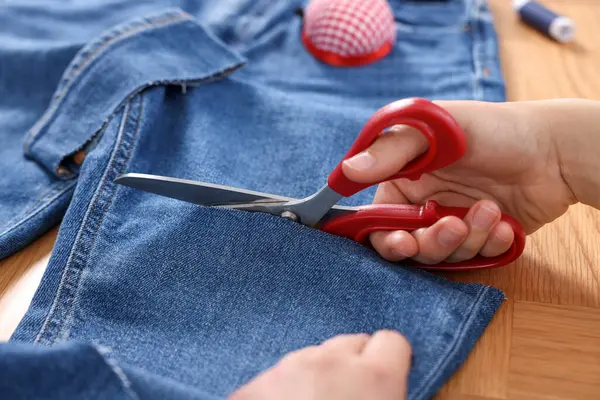Woman Cutting Jeans Scissors Wooden Table Closeup — Stock Photo, Image