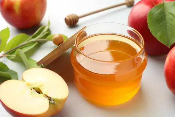 stock image Sweet honey and fresh apples on white table, closeup