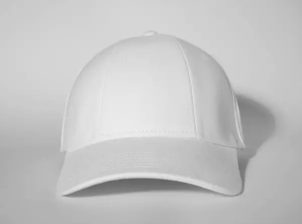 stock image Stylish white baseball cap on light background