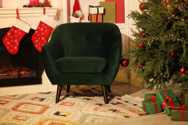 Living room interior with fireplace, armchair and Christmas decor