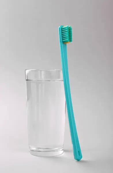 Plastic Toothbrush Glass Water Light Background Stock Image