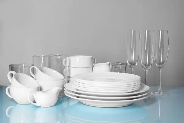 Set Clean Dishes Glasses Light Blue Table Gray Background — Stock Photo, Image