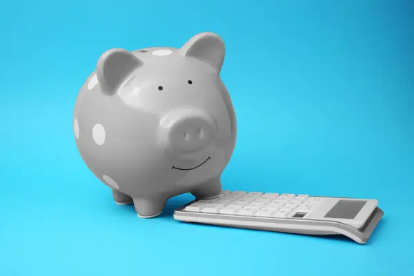 Piggy Banco Calculadora Fundo Azul Claro — Fotografia de Stock
