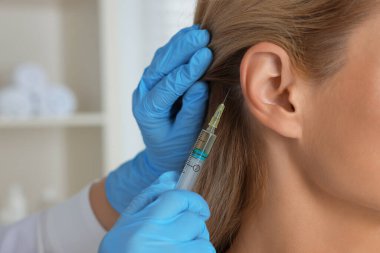 Trikoloğum klinikteki hastaya iğne yapıyor.