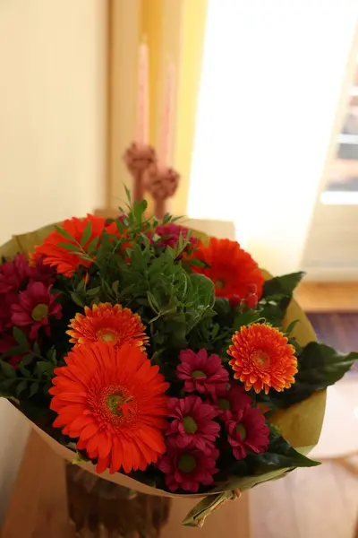 Bouquet of flowers on wooden table indoors, closeup