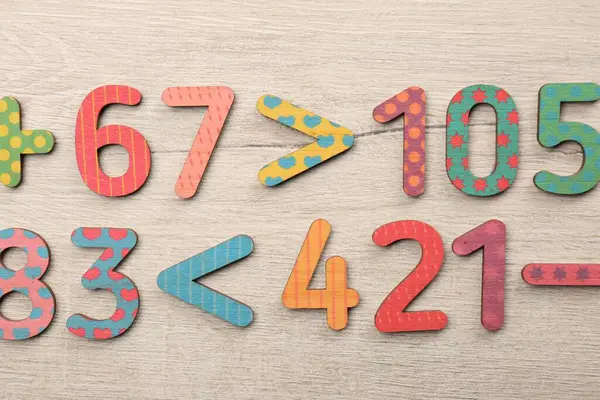 Colorful Numbers Mathematical Symbols Light Wooden Table Flat Lay Stock Image
