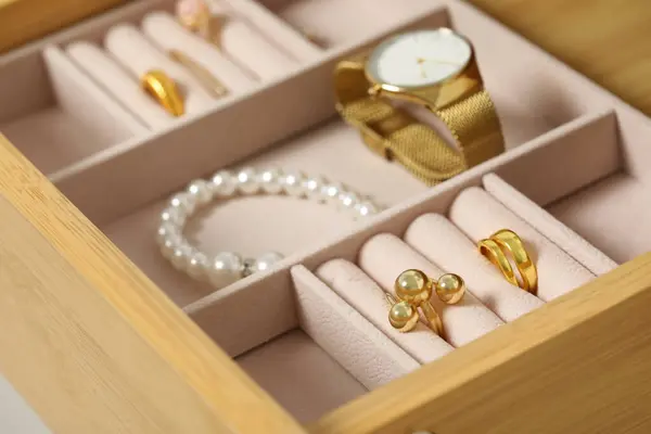 Jewelry box with many different accessories in wooden drawer, closeup