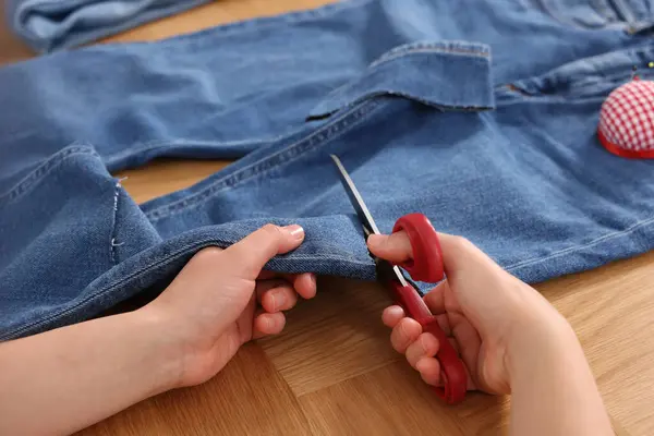Woman Cutting Jeans Scissors Wooden Table Closeup — Stock Photo, Image