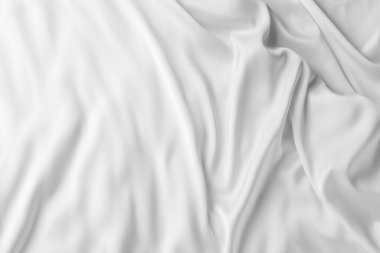 Arka plan olarak beyaz ipek dalgalı kumaş dokusu, üst görünüm