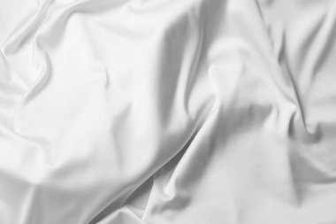 Arka plan olarak beyaz ipek dalgalı kumaş dokusu, üst görünüm