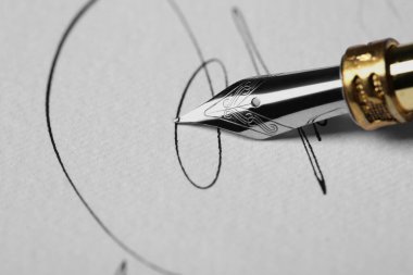 Dolma kalemle kağıda imza atmak, yakın plan.