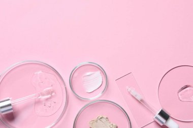 Pipettes, cosmetic serum and petri dishes with samples on pink background, flat lay. Space for text clipart