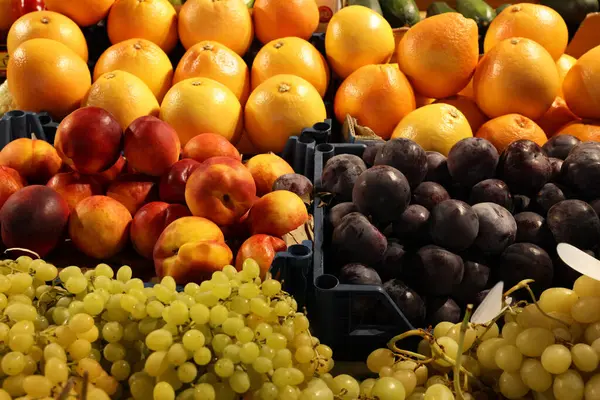 Many different fresh fruits on counter at market, closeup