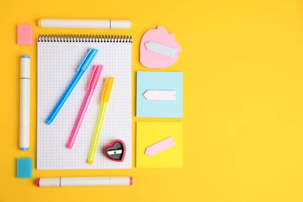 Different school stationery on yellow background, flat lay with space for text. Back to school