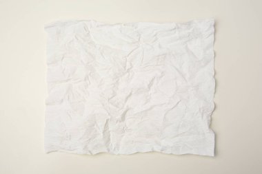 Bej arkaplan üzerine buruşuk kağıt yaprağı, üst görünüm