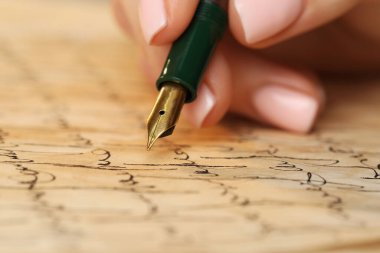 Woman writing letter with fountain pen, closeup clipart