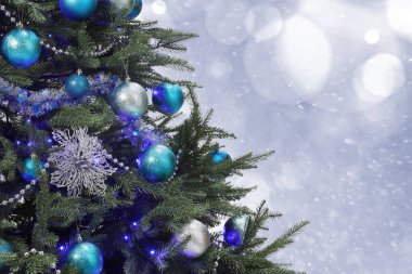 Açık mavi ve gümüş renkli toplarla süslenmiş Noel ağacı bulanık arka plan, bokeh etkisi. Metin için boşluk