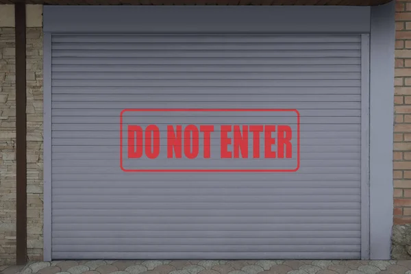 Text Do Not Enter on roller shutter garage door outdoors