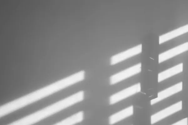 Lines made of light and shadows on white wall