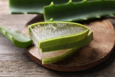 Dilimler taze aloe vera yaprakları ahşap masa üzerinde jöle, yakın çekim