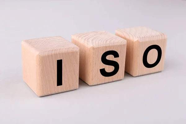 International Organization for Standardization. Cubes with abbreviation ISO on light grey background, closeup