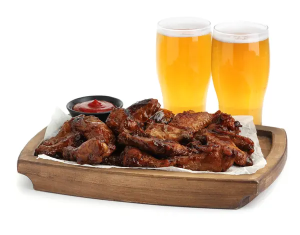 Tasty chicken wings, glasses of beer and ketchup isolated on white. Delicious snack