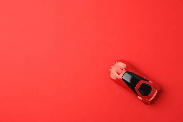 One bright car on red background, top view. Space for text
