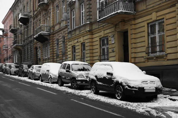 Parked cars on city street in winter
