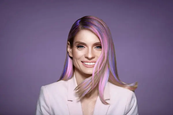 Hair styling. Gorgeous woman with colorful hair on light purple background