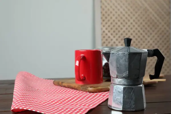 Moka pot on wooden table indoors, space for text
