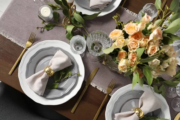 Beautiful table setting with floral decor, flat lay