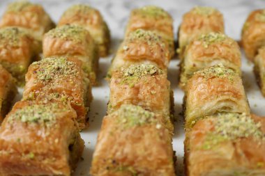 Beyaz masada doğranmış fındıklı enfes taze baklava, yakın plan. Doğu tatlıları