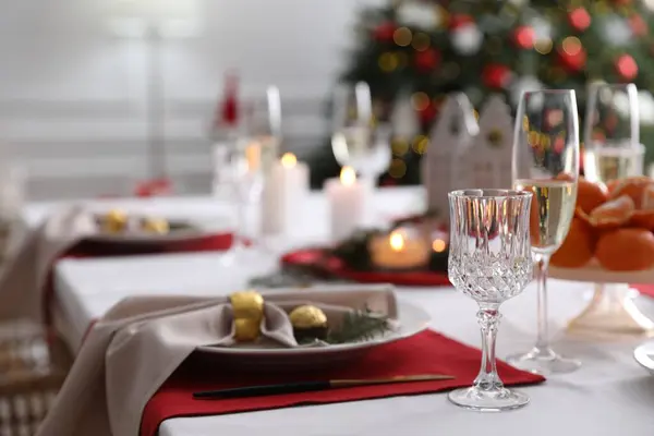 Christmas table setting with beautiful napkin, cutlery and dishware indoors