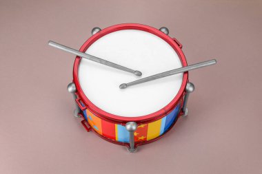 Colorful drum and sticks on dusty rose background. Percussion musical instrument clipart